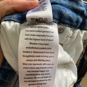 Good American jeans. High waisted, straight leg with frayed hem.